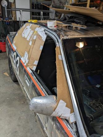 Cardboard covering rear windows as prototype and template for the polycarb windows.